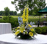 yellow and blue delphinium centerpiece