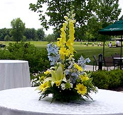 yellow and blue delphinium centerpiece